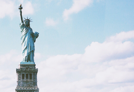 statute of liberty in front of clouds